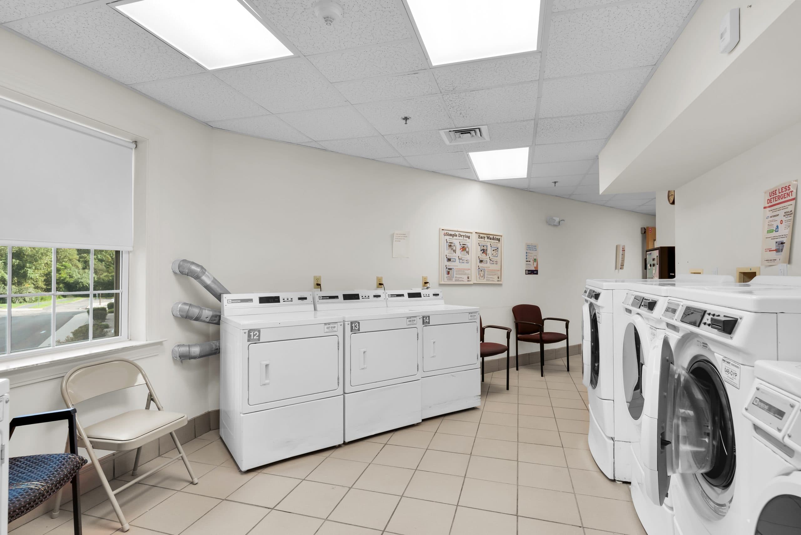 The on-site laundry room, with washers and dryers along a bright, tiled room